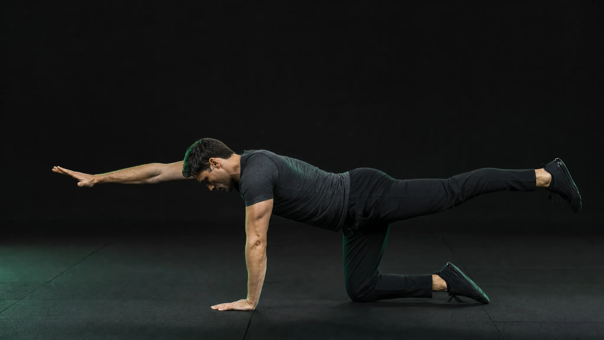 Person performing a controlled bird-dog exercise