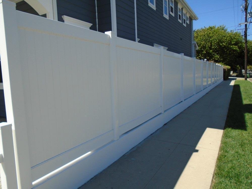 White vinyl side-yard fencing by All Season Fencing