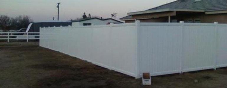 White vinyl backyard privacy fencing by All Season Fencing
