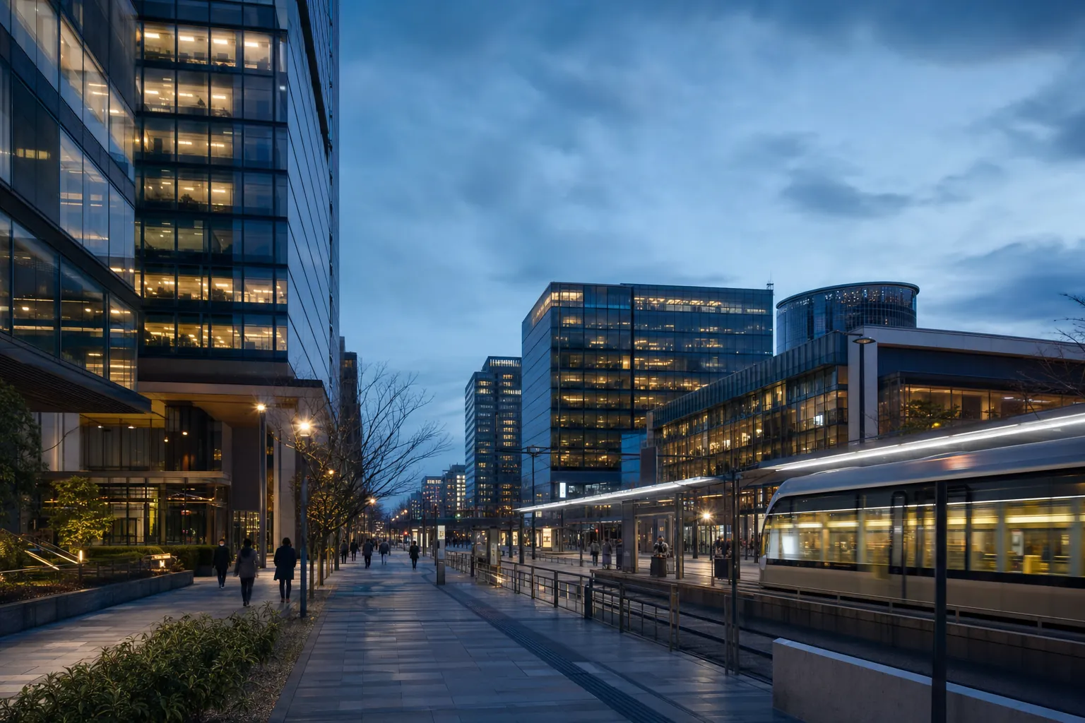 A modern city transit corridor and commercial buildings at blue hour.