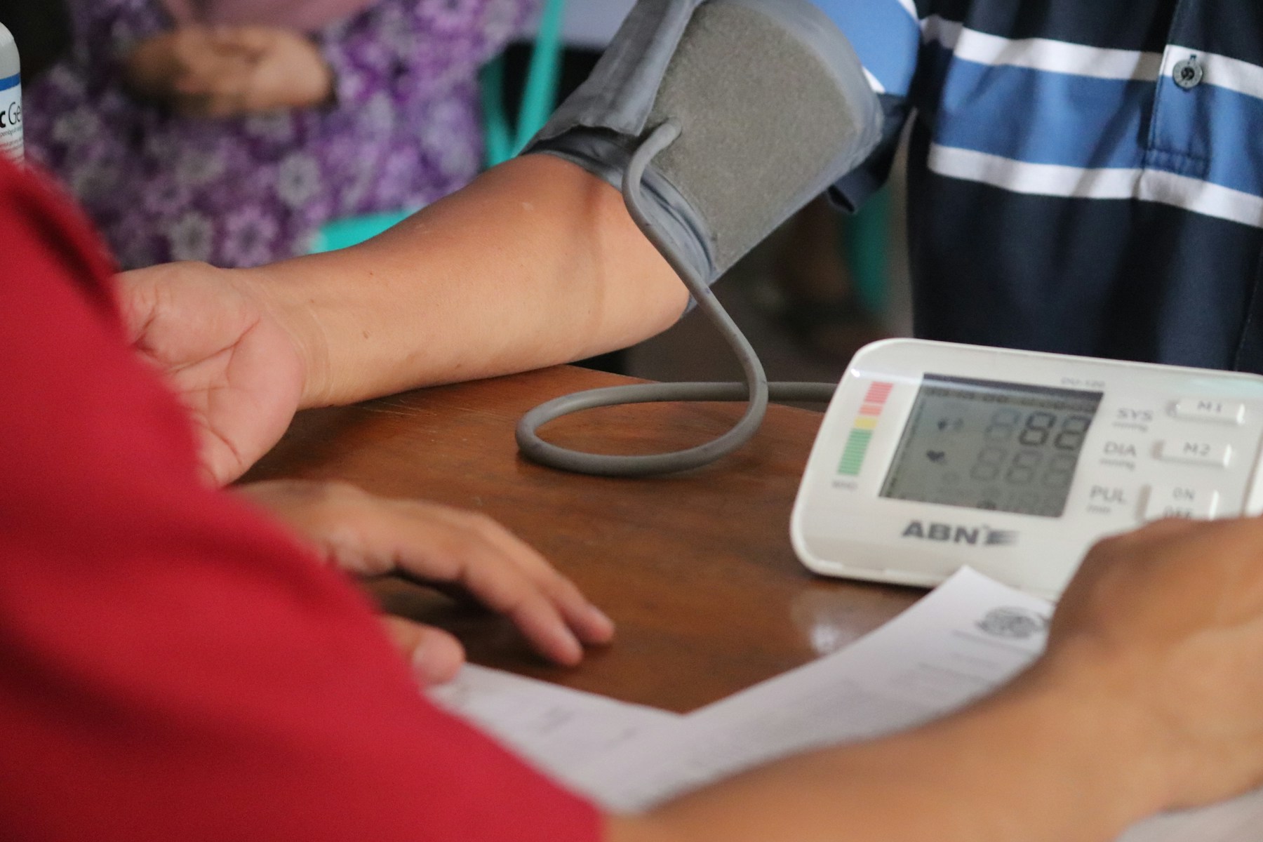 A person having their blood pressure checked during a health appointment