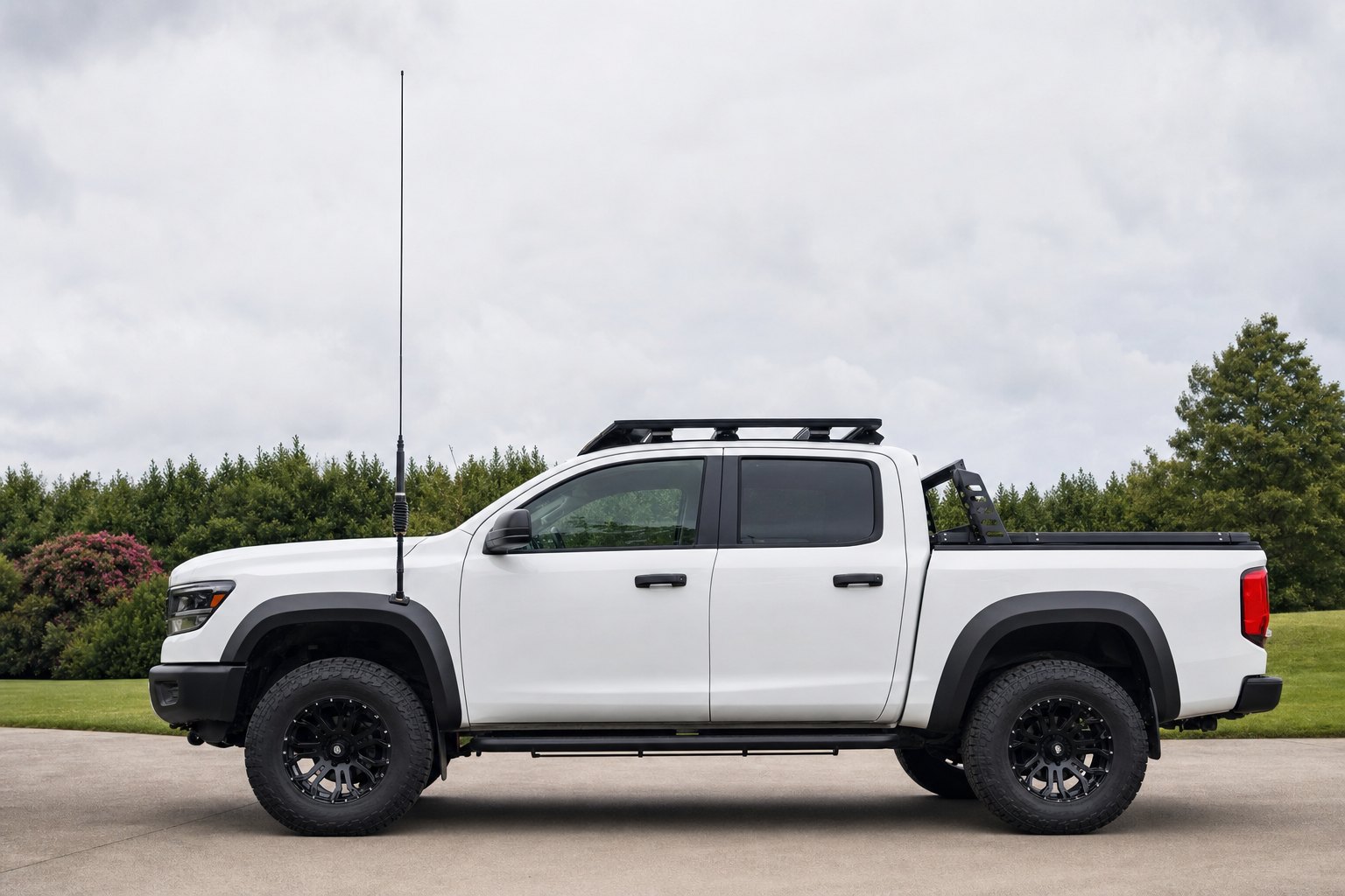 Pickup truck with a CB antenna whip mounted clear of the cab and roof rack