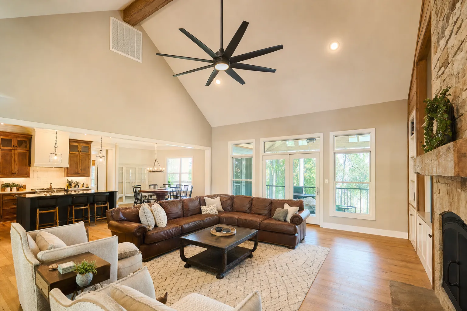 Large ceiling fan mounted on a downrod in a vaulted living room