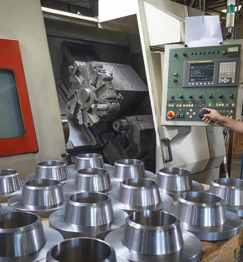 Aluminum flanges in front of a CNC manufacturing machine