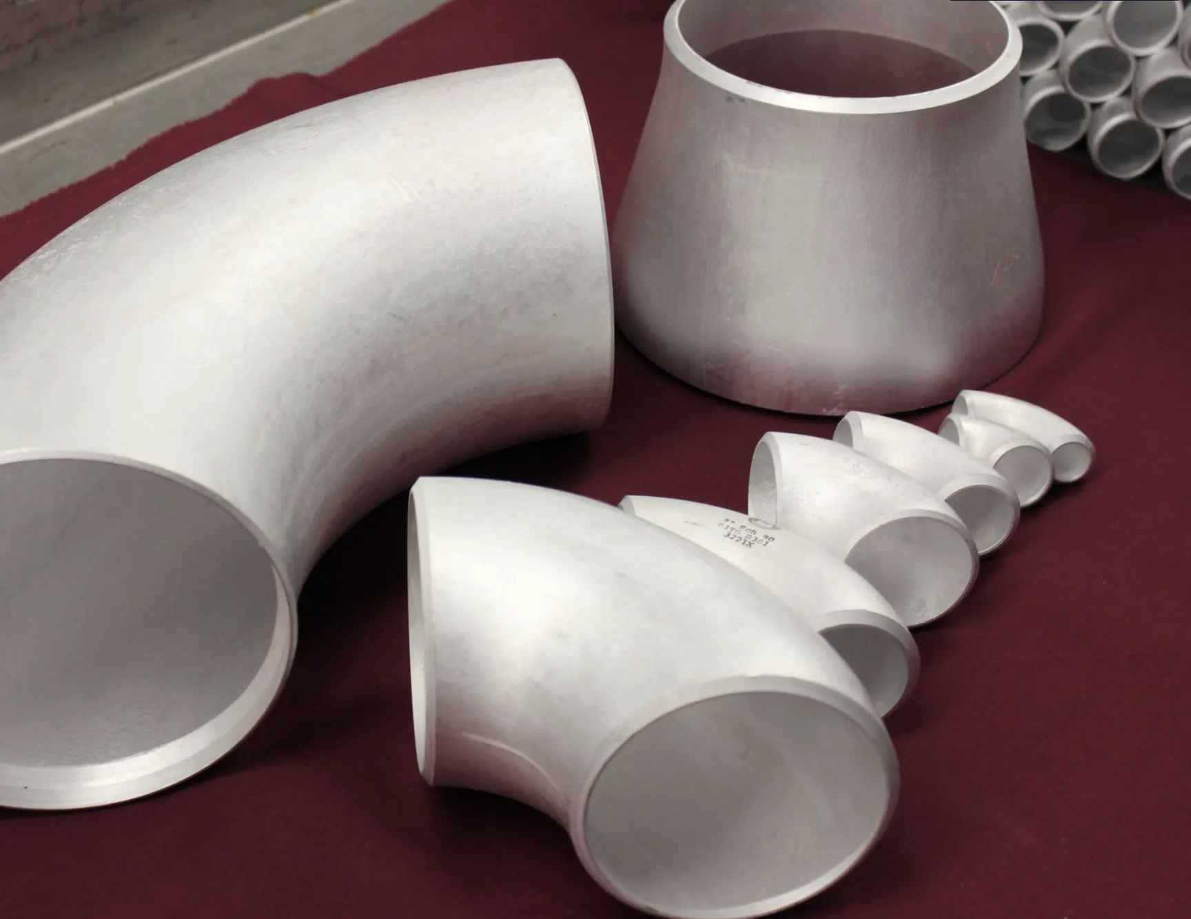 Aluminum elbow, tee and reducer fittings on an inspection table