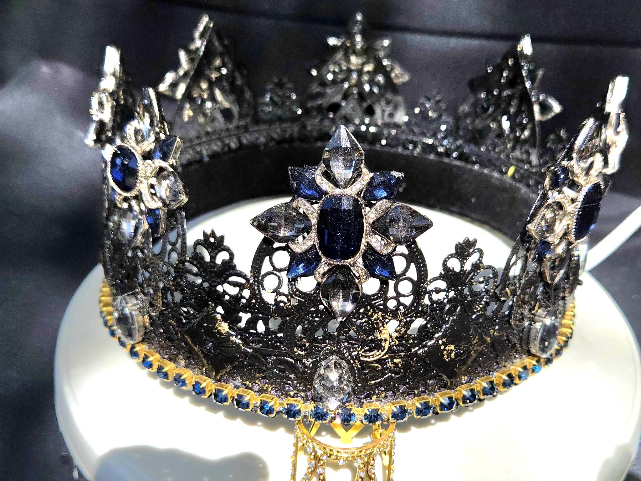 Darkstar black lacquered crown with brushed gold accents and blue stones