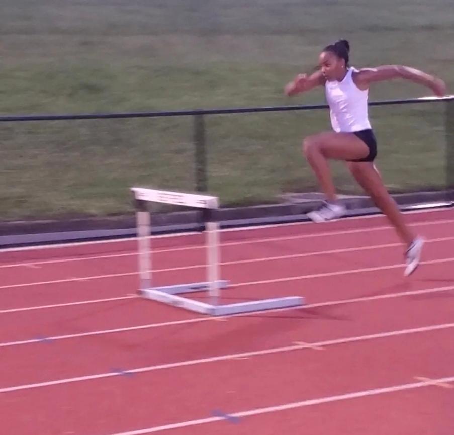 Virginia Pride athlete practicing hurdle technique on an outdoor track