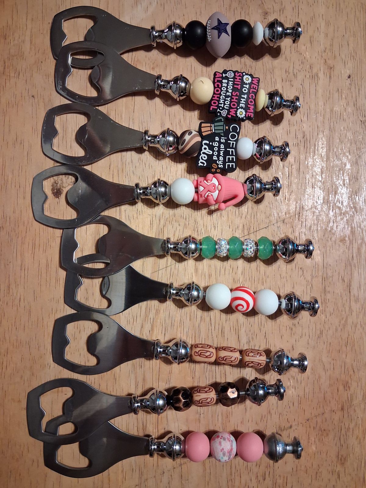 Silver bottle openers with colorful beaded handles, sparkling spacers, and decorative charms