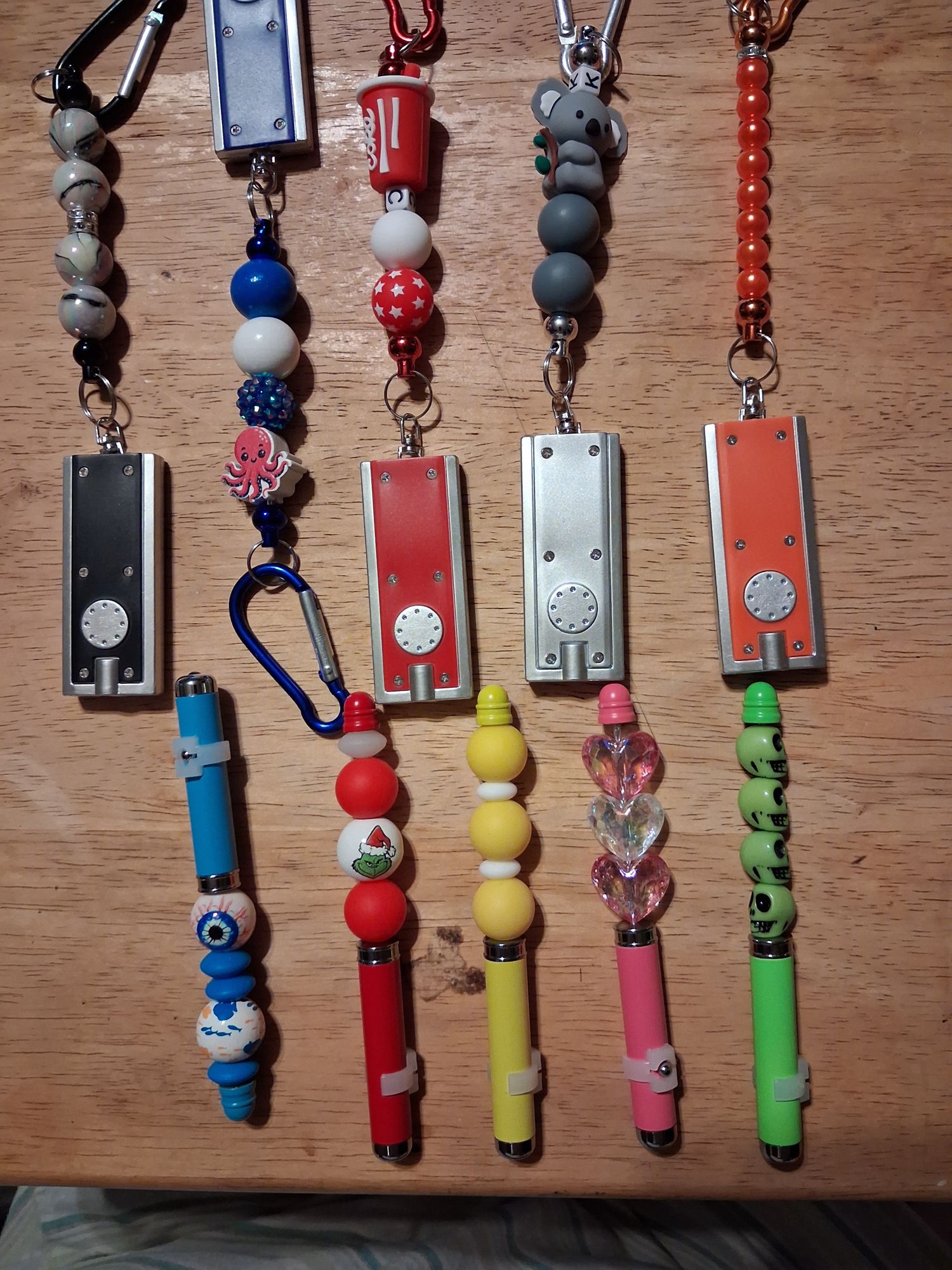 Theresa’s colorful beaded flashlights arranged on a wooden table