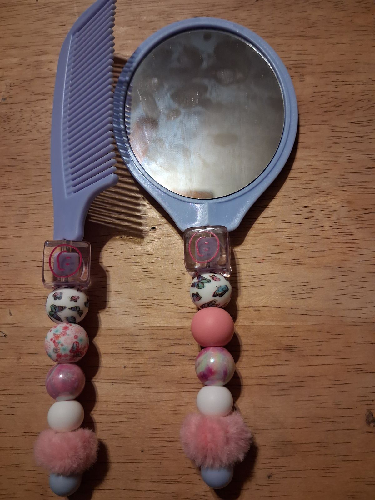 Lavender mirror and comb with pink and patterned beaded handles and fluffy pink details