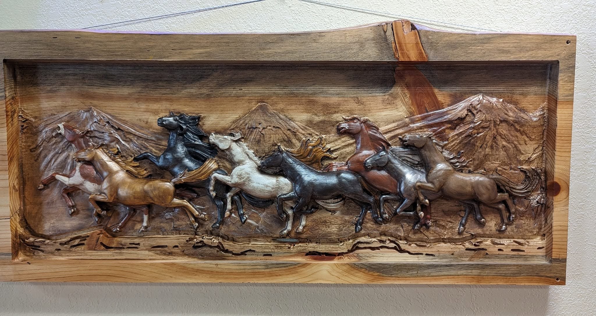Carved running horses wall relief