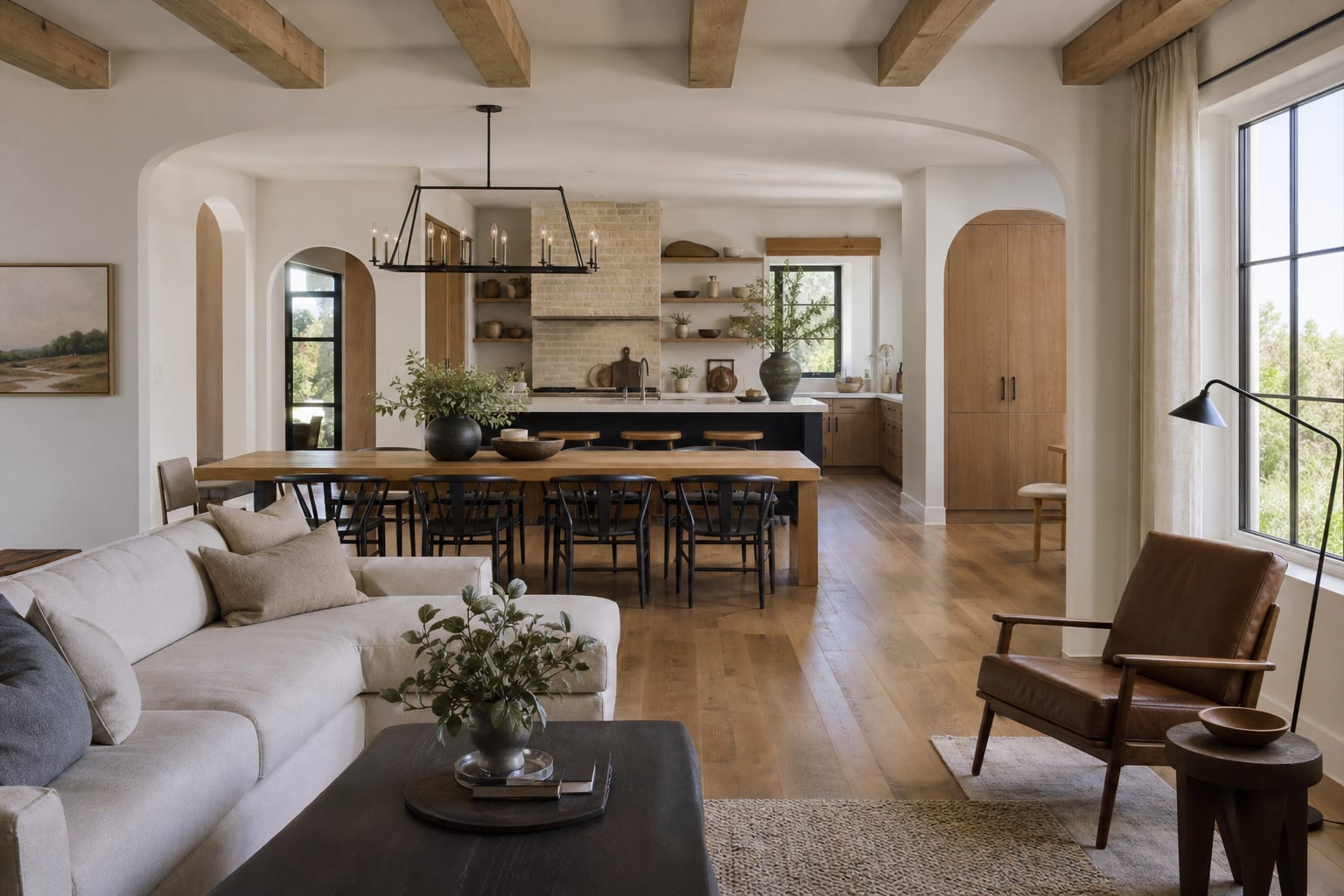 Warm finished kitchen, dining, and living spaces with daylight and natural materials
