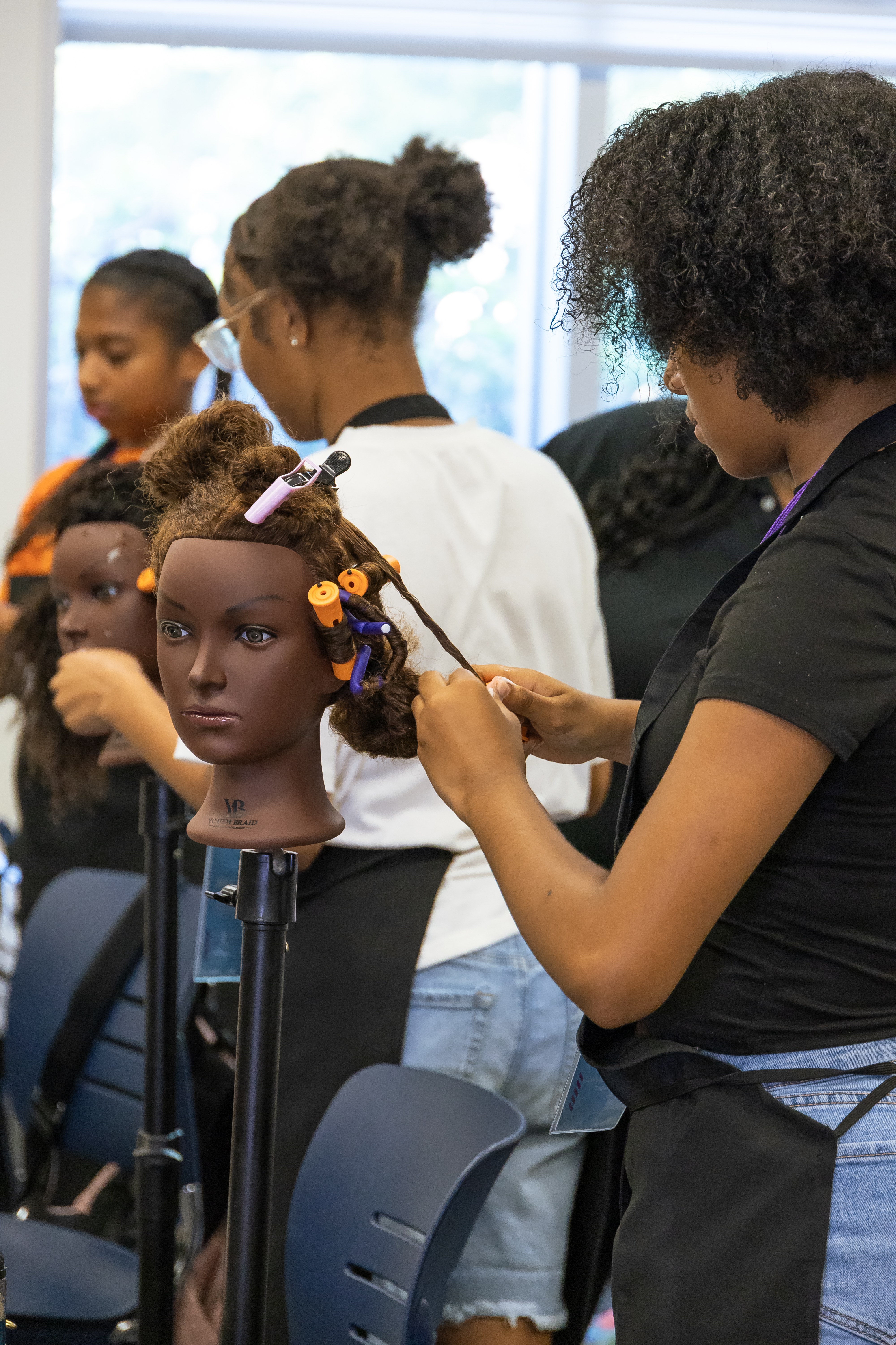 Young people working together in a braiding class