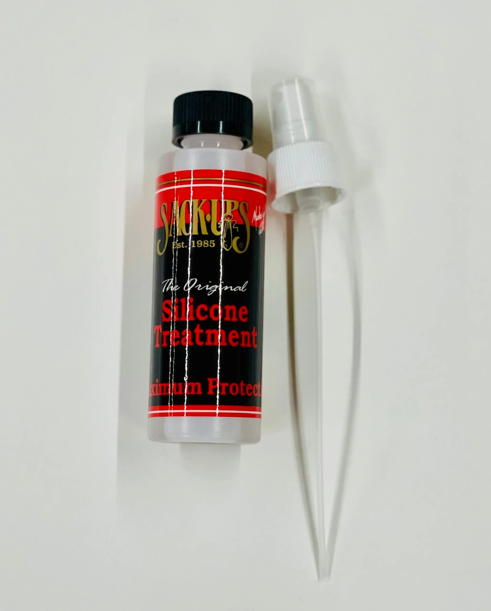 Sack-Ups silicone treatment bottle beside its applicator