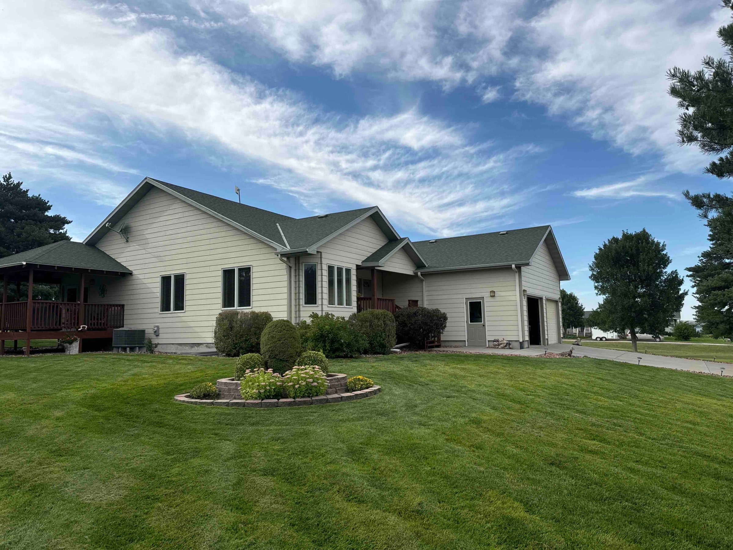Completed Nebraska home with a dark shingle roof