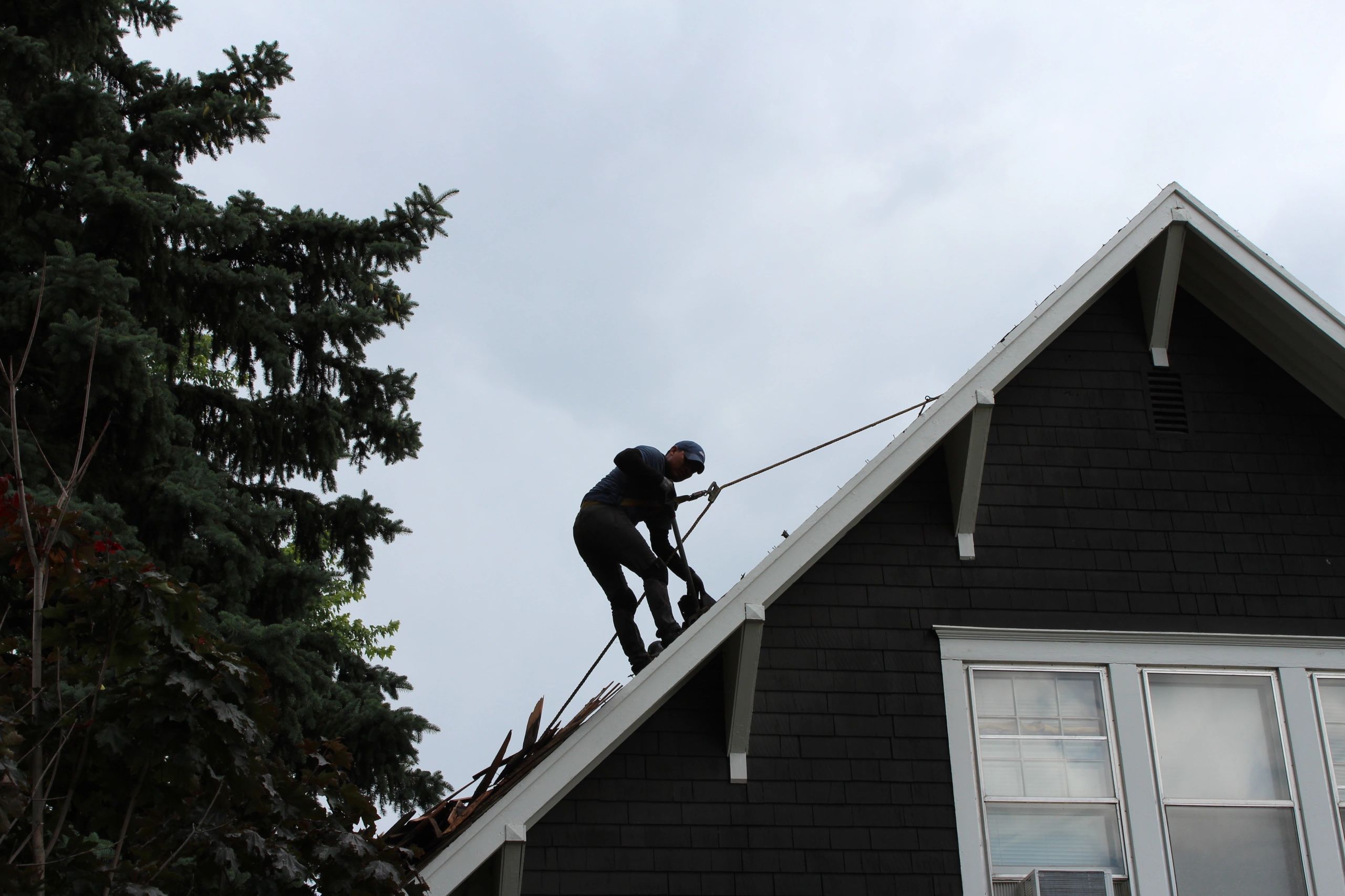 ROOF911 worker on a steep roof