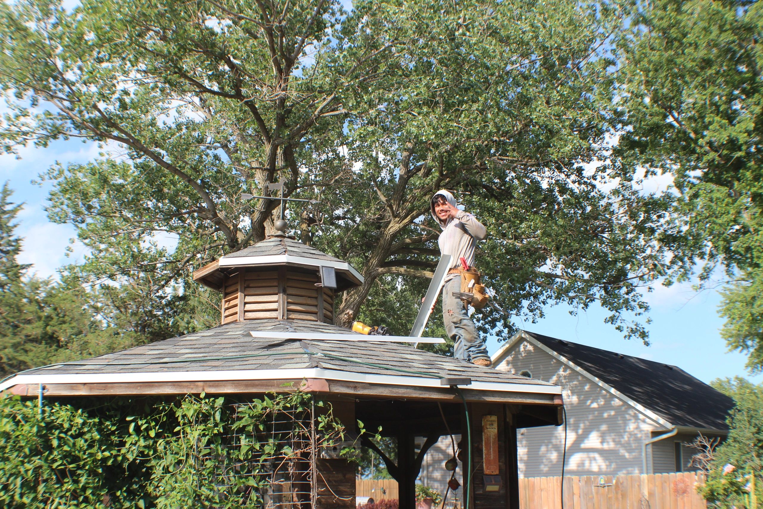 Worker on a gazebo roof