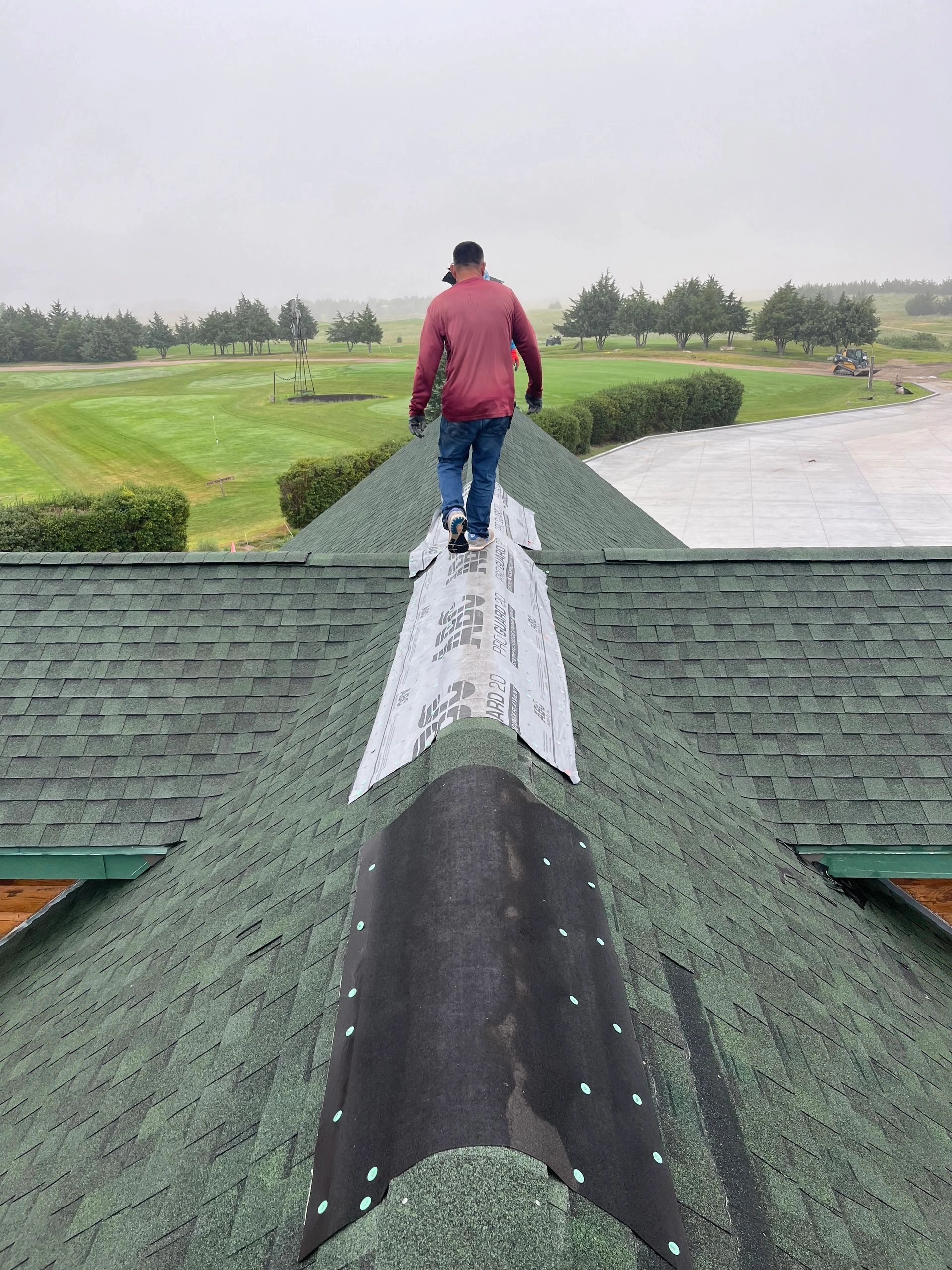 Worker repairing a roof ridge