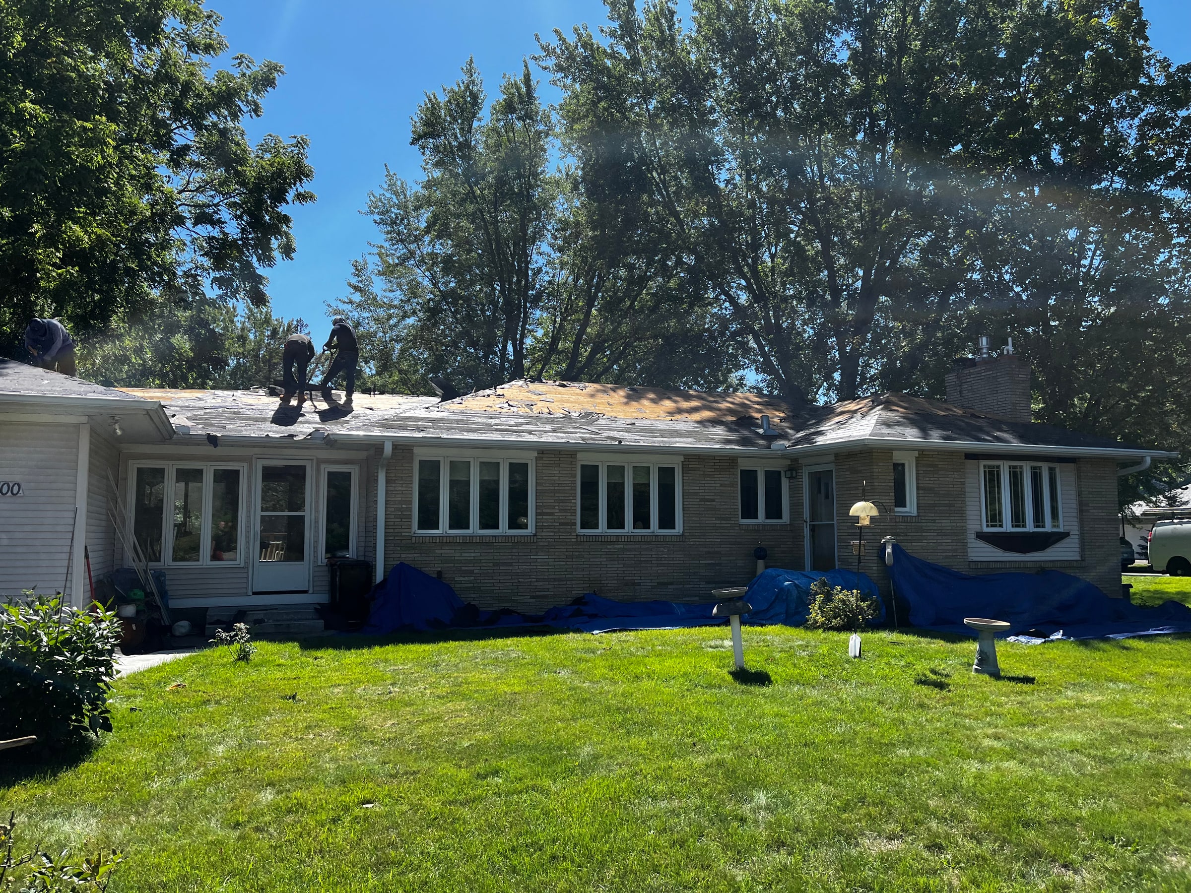 Roofing crew completing a residential tear-off