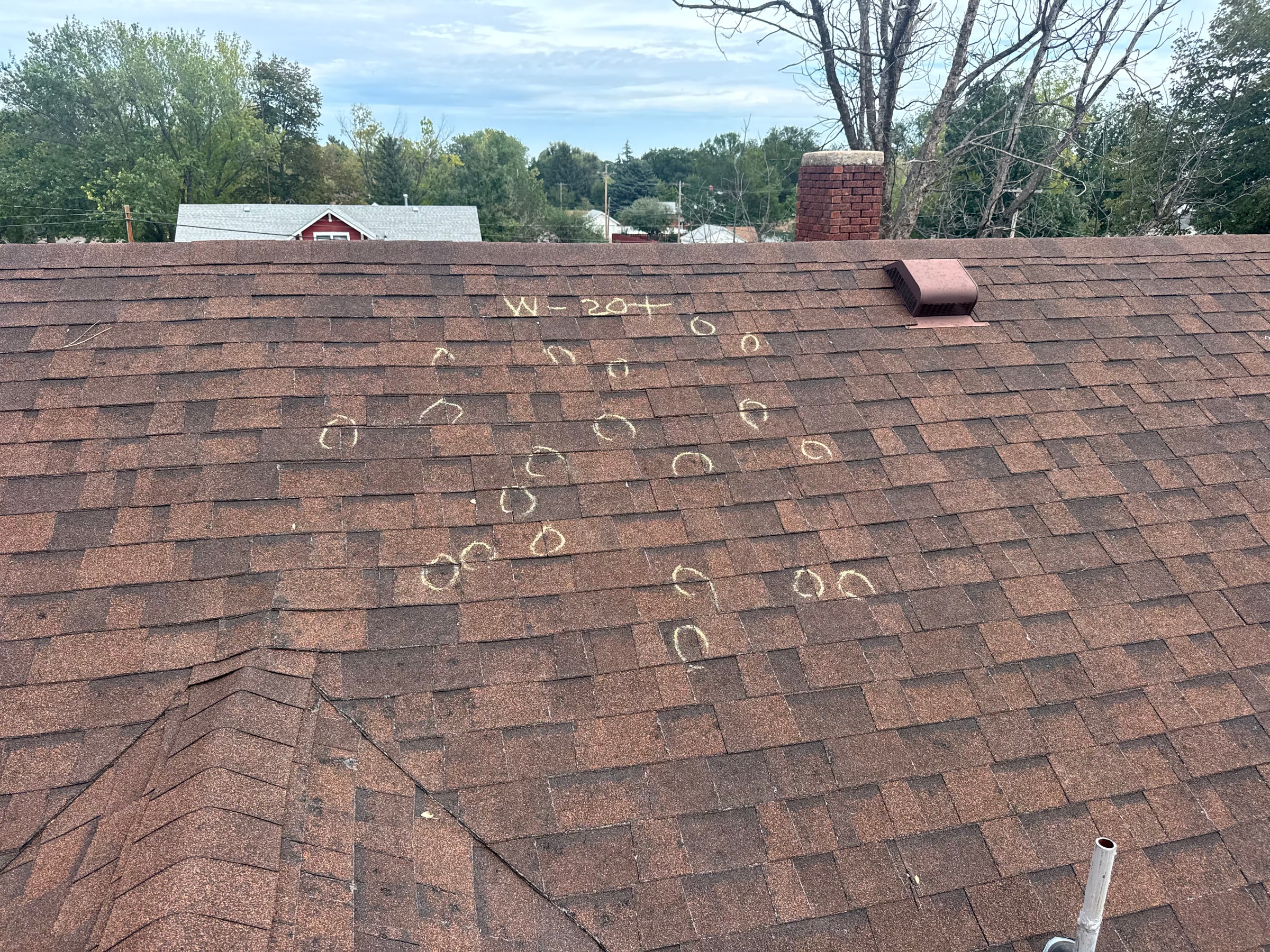 Close roof inspection with marked shingle details