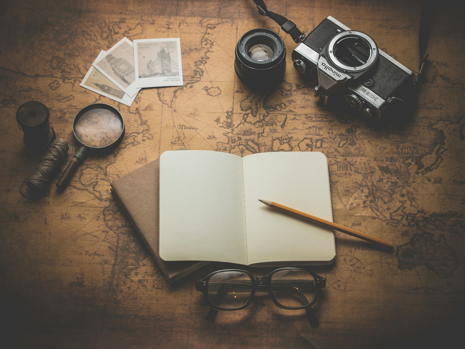 Field notebook and navigation tools on an old map