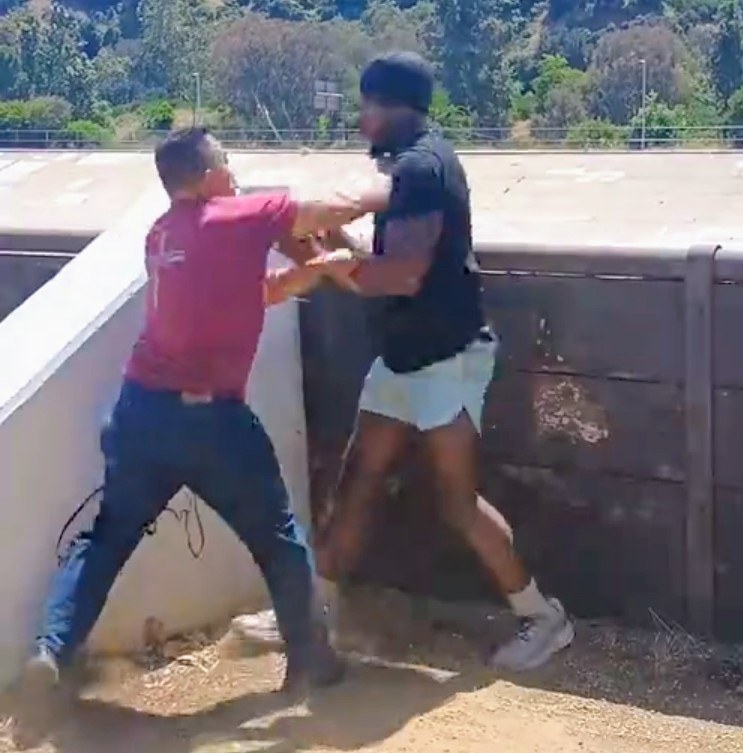 Vinny Cruz demonstrating self-defense outdoors with a client
