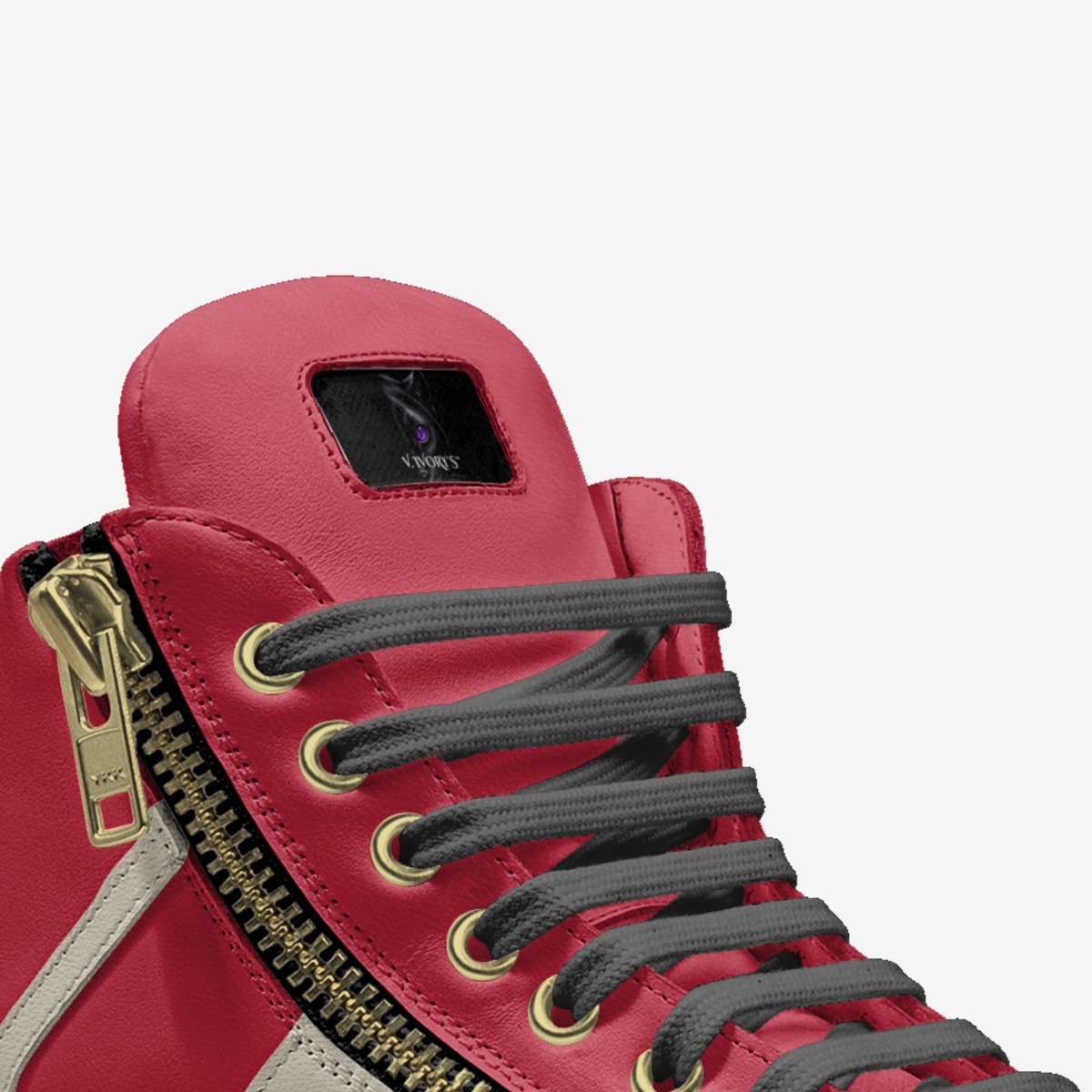 Close detail of Panther I Crimson Ivory footwear with gold zipper