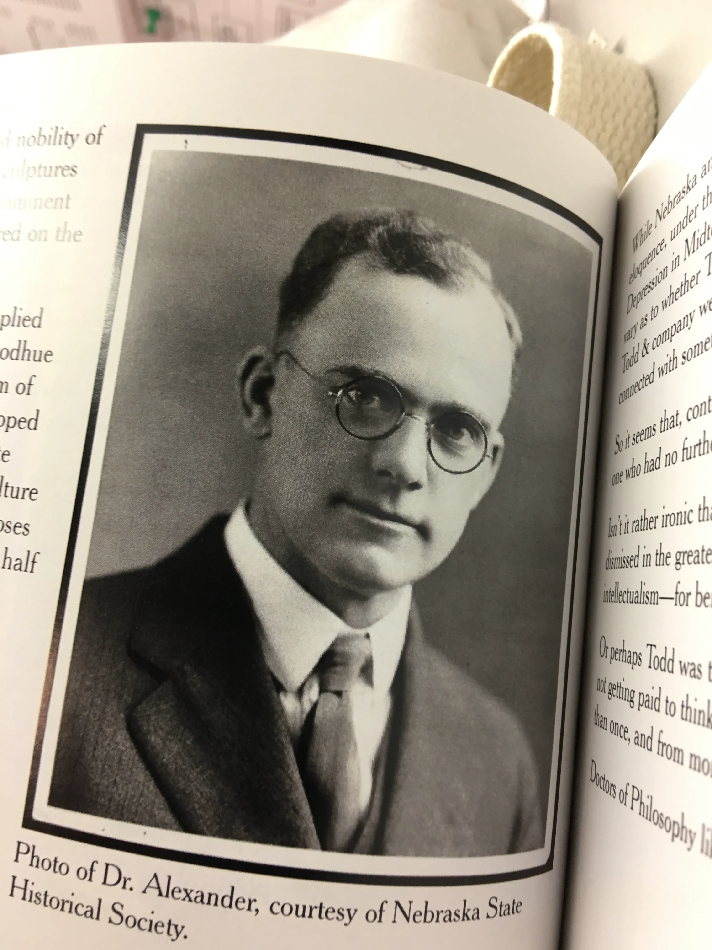 Historic portrait of Dr. Hartley Burr Alexander in a dark suit, tie and round glasses.
