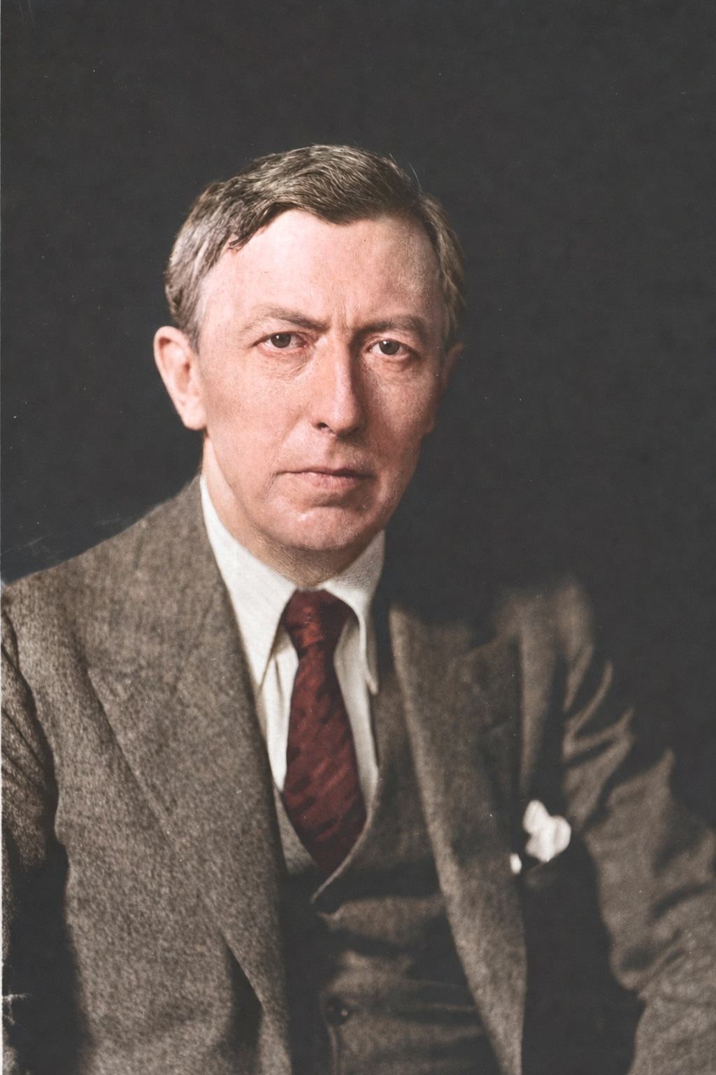 Colorized portrait of Lee Lawrie in a suit and tie