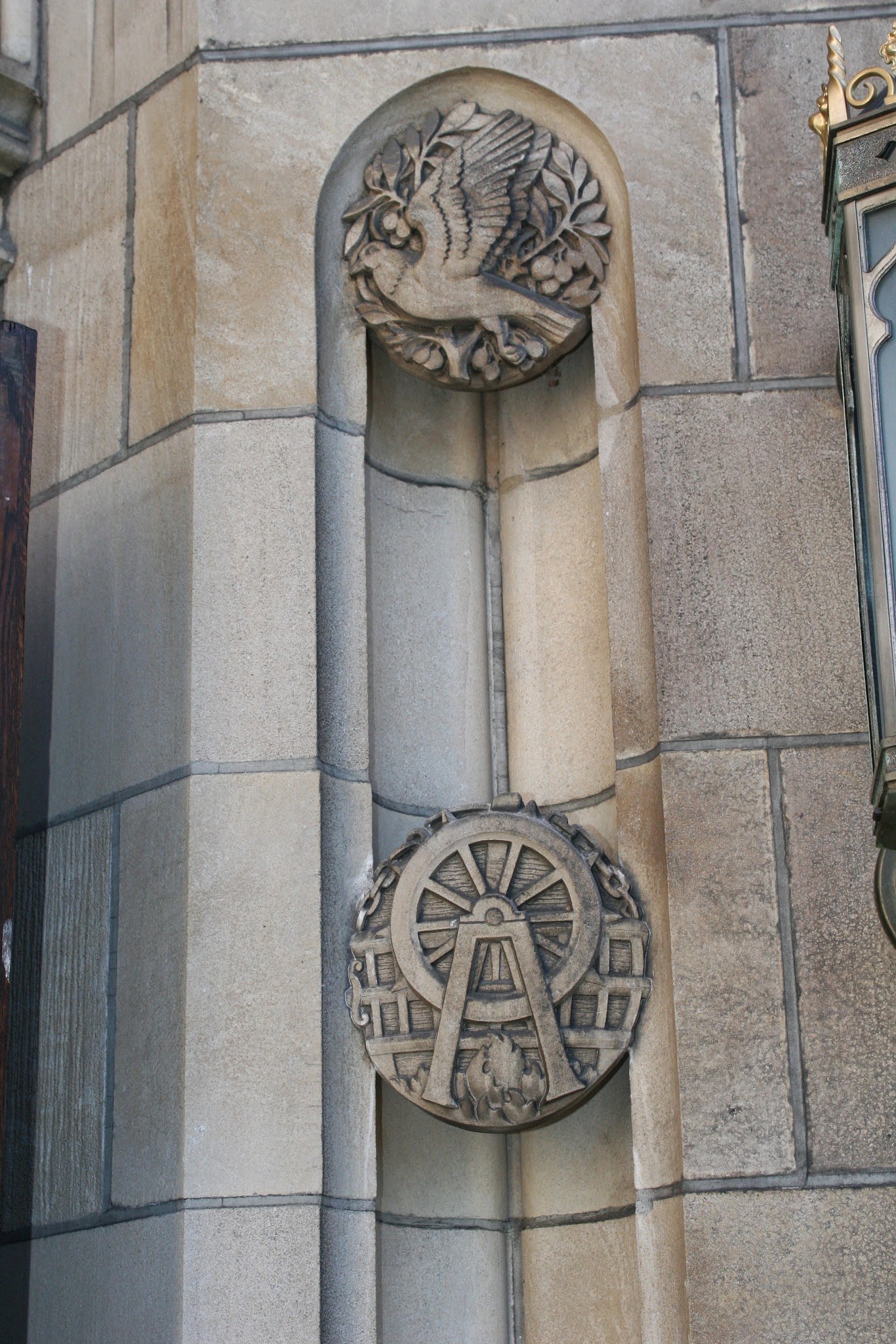 Carved figure and ornamental wheel on the church facade