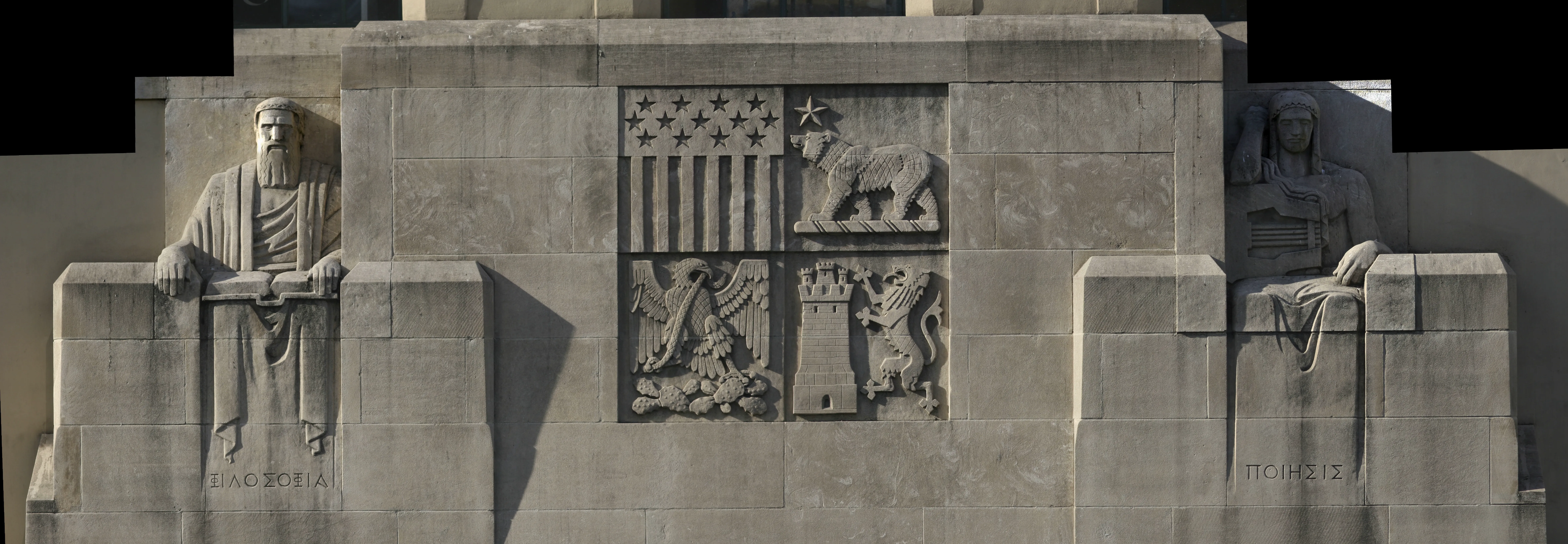 Photograph of The Philosopher, the Poet and the Library’s Coat of Arms, Wide view of the north entrance. An archival document identifies the Poet as “Poesy,” meaning the art of writing poetry. At centre, the coat of arms combines an American flag motif, the California bear, a Mexican eagle on a cactus with a snake, and the English lion and castle., from Lee Lawrie’s Los Angeles, California collection.