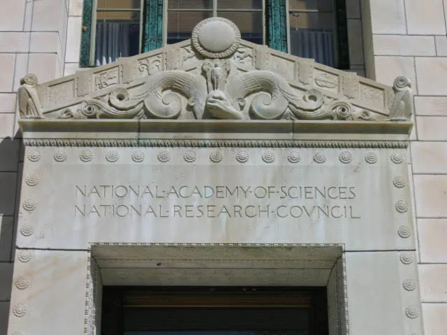Pediment detail, framed by owls and the symbolic border, National Academy of Sciences Building · Washington, D.C.
