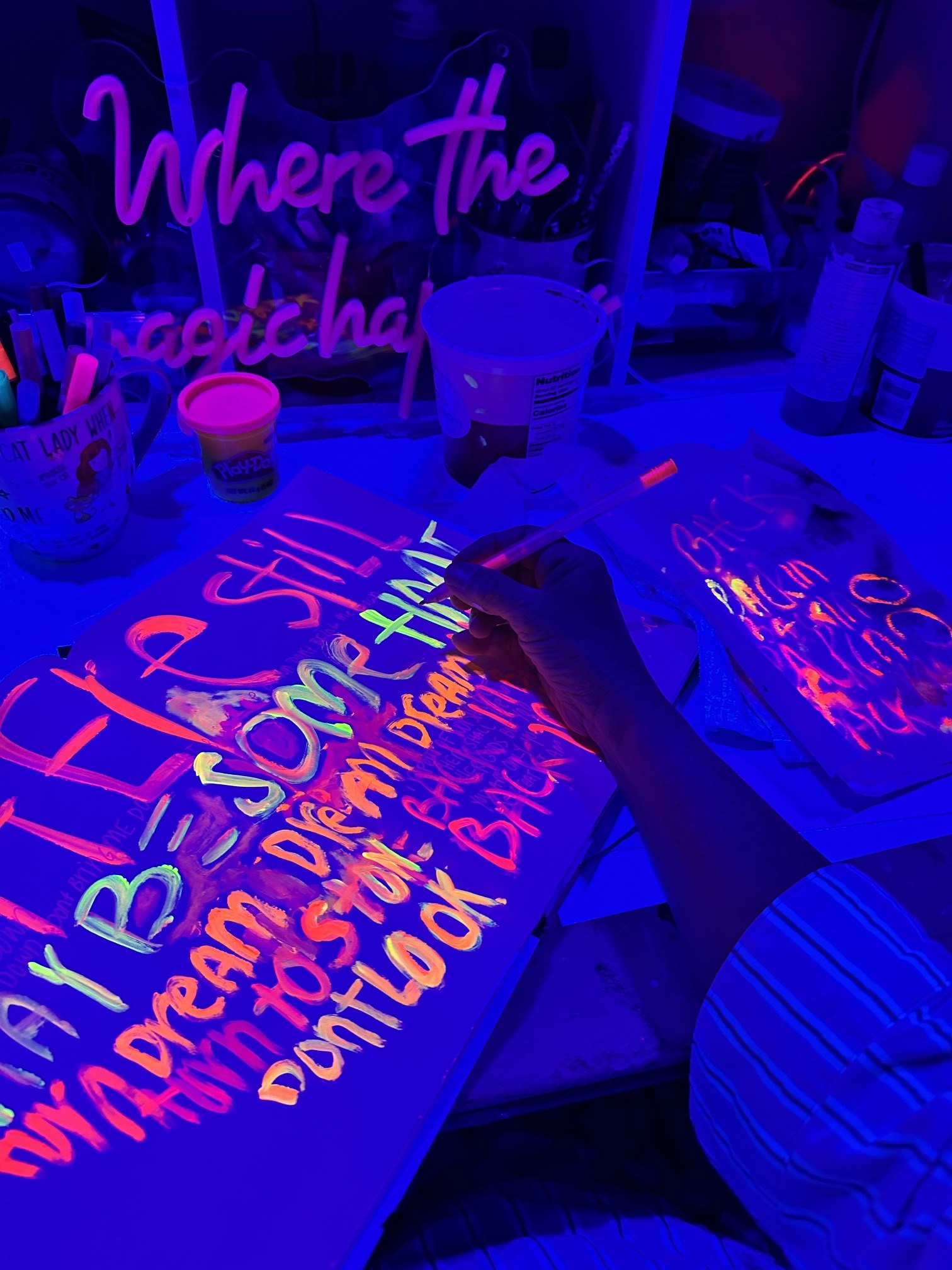 Michelle Johnson Fairchild working with fluorescent paint under black light