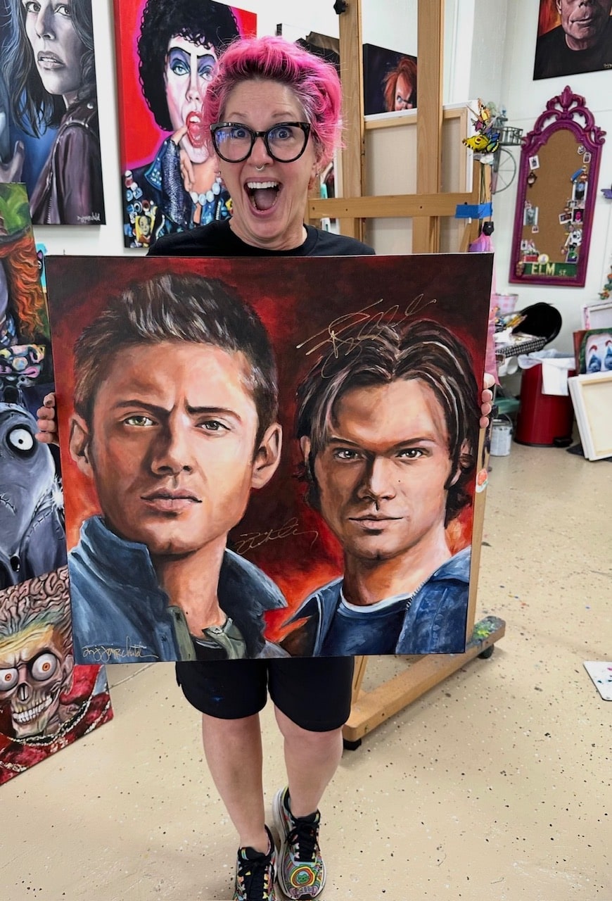 Michelle Johnson Fairchild holding her autographed Sam and Dean portrait