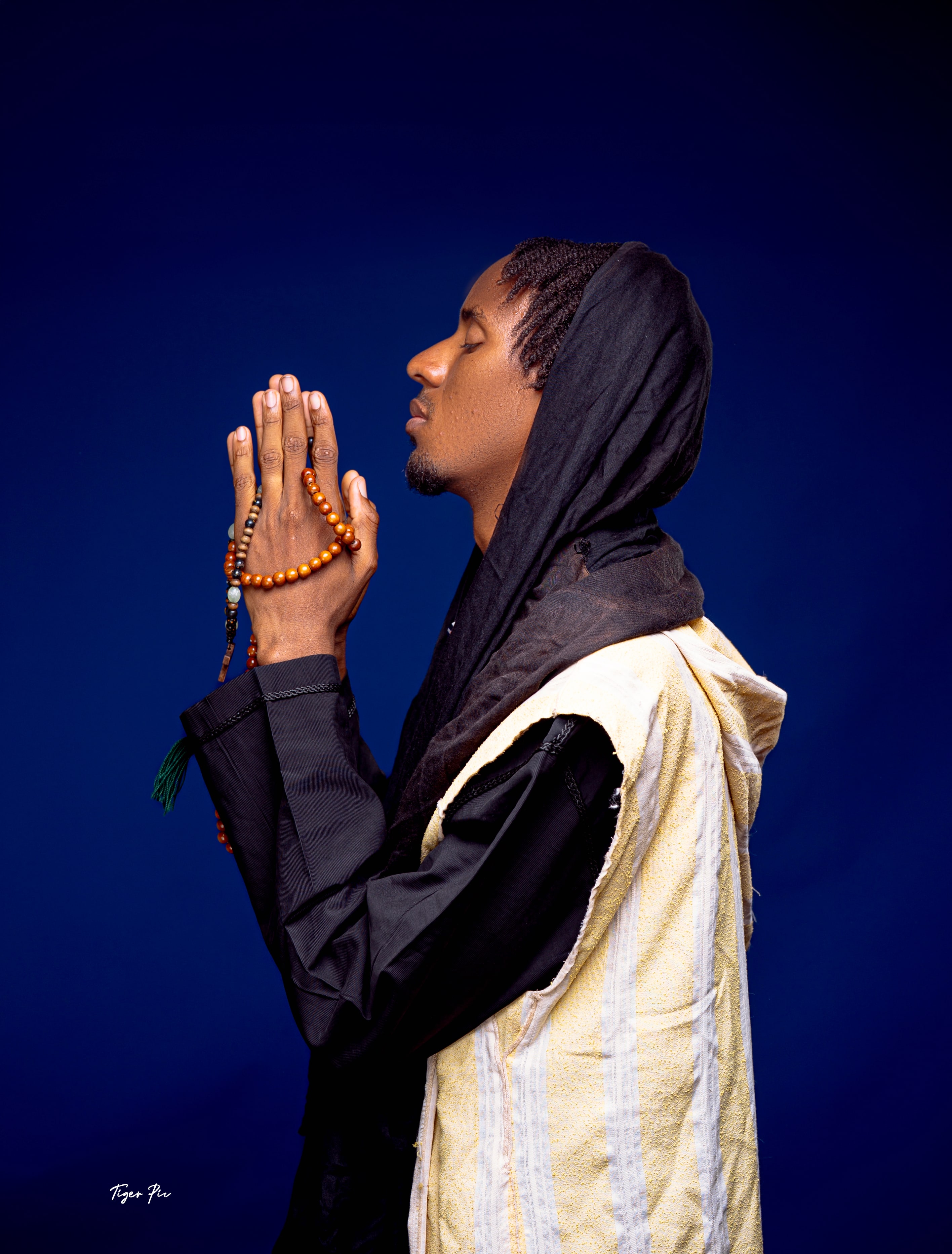 David 6D in a black hooded outfit against a blue background