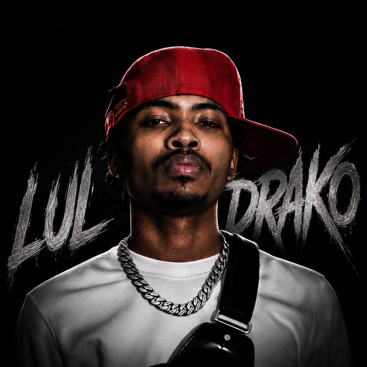 Close-up Lul Drako portrait with a red cap and artist name backdrop