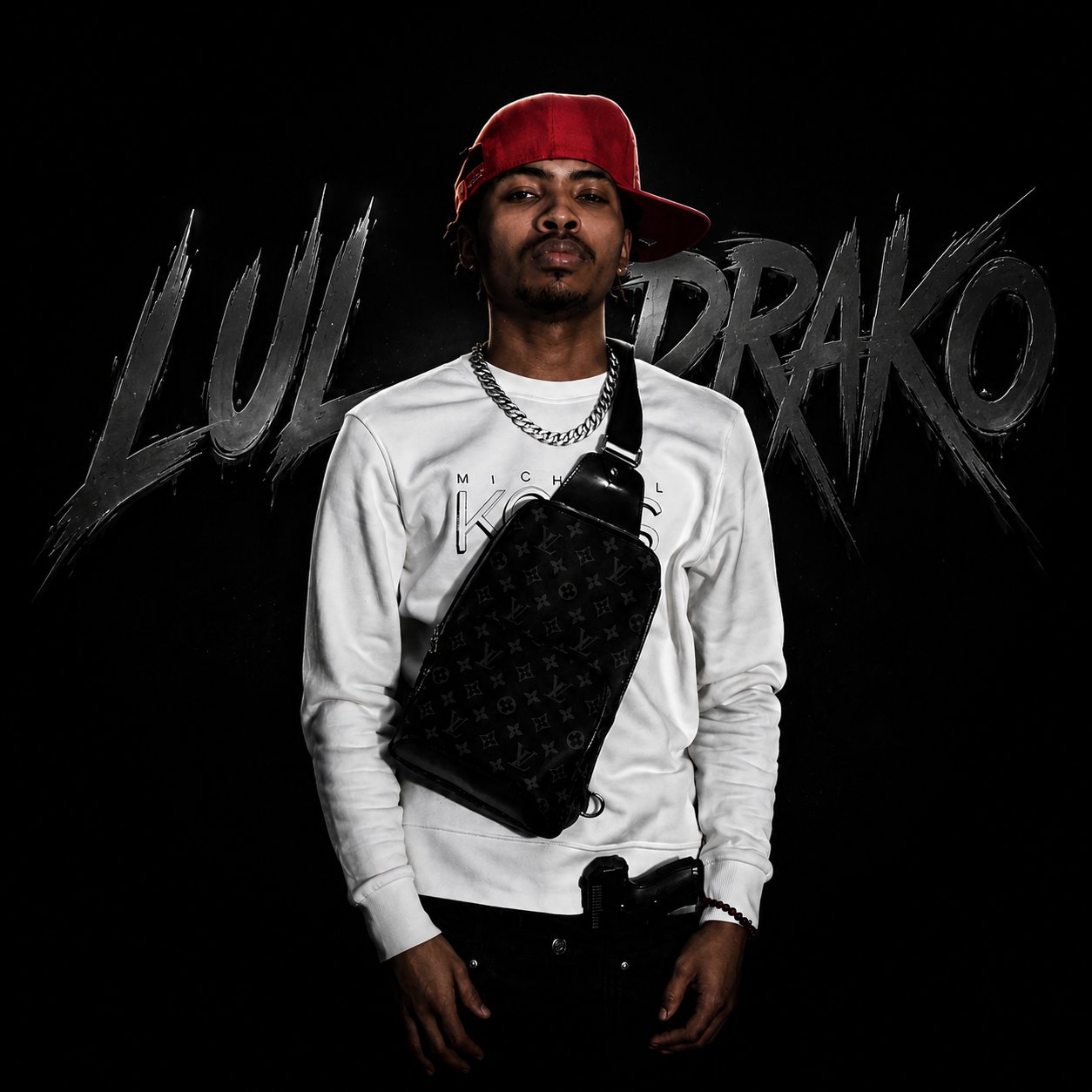 Lul Drako wearing a red cap and white shirt against his artist name backdrop