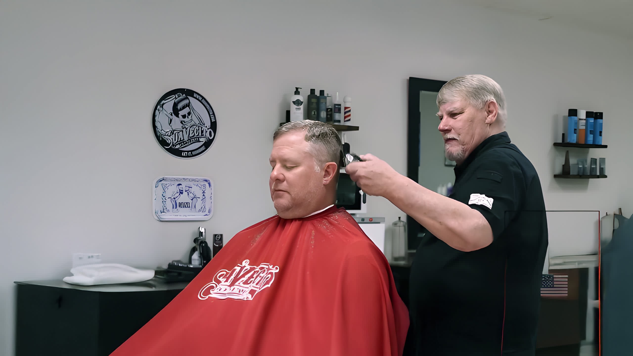 Barber finishing a haircut at Woody’s Barber Shop