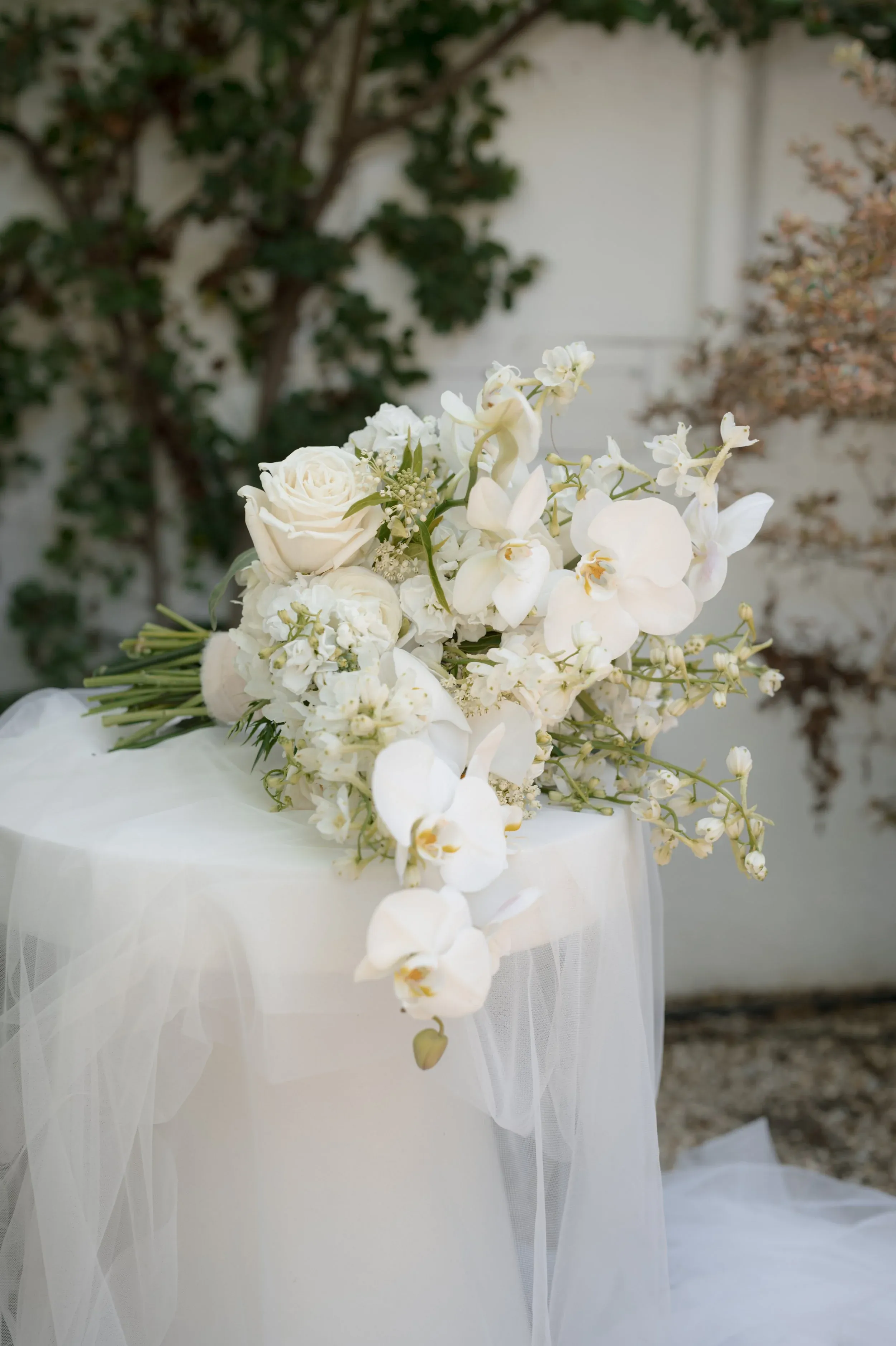 White orchids and roses arranged for a wedding at Islay Gardens