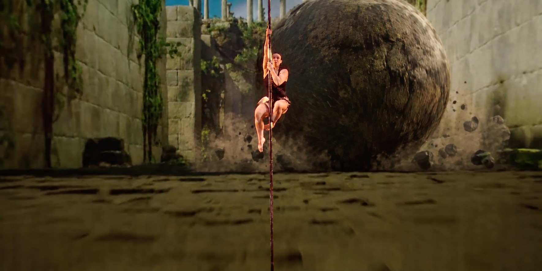 Kristy Sellars performing beside a giant boulder