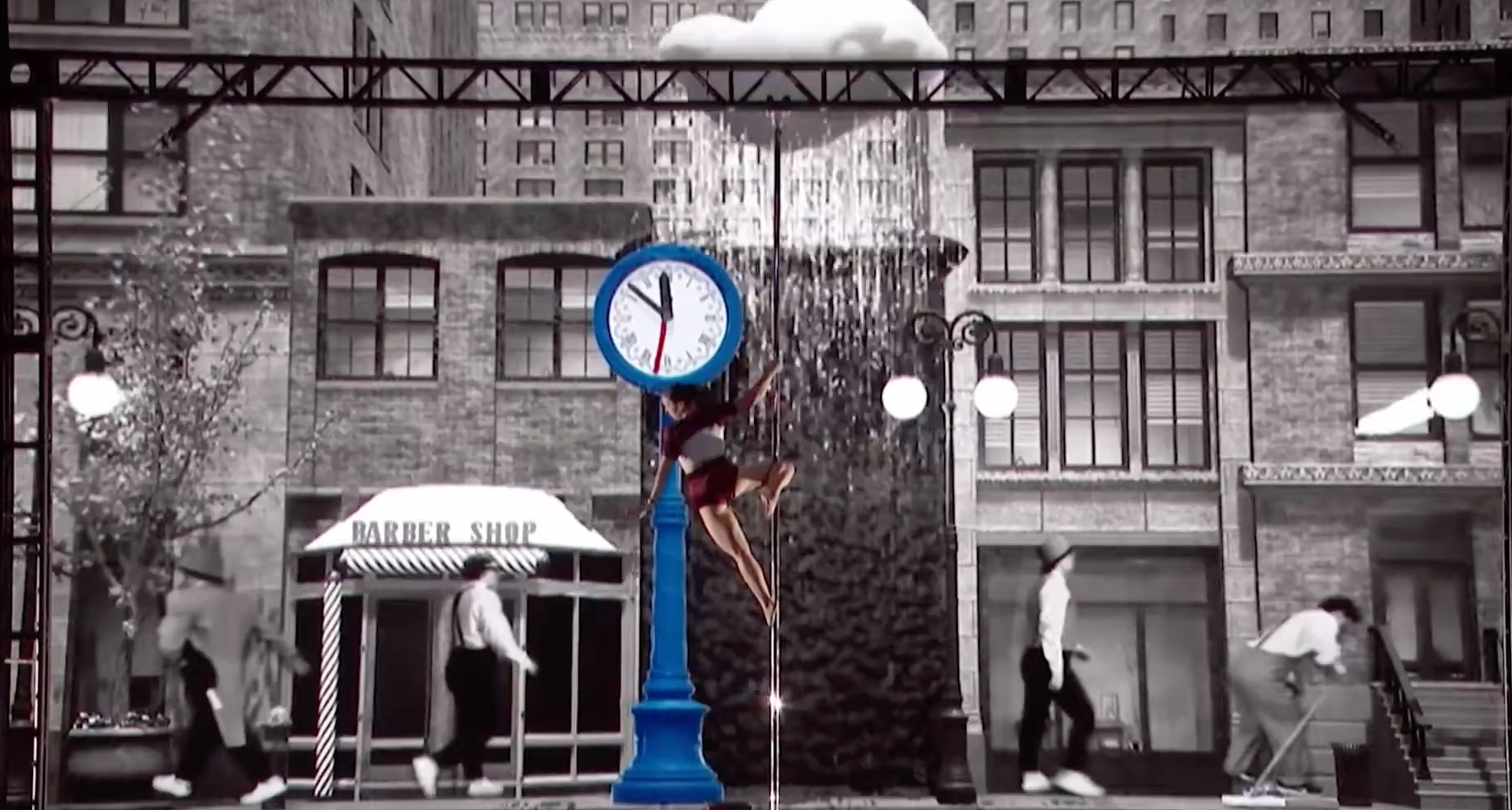 Kristy Sellars performing in front of a giant clock