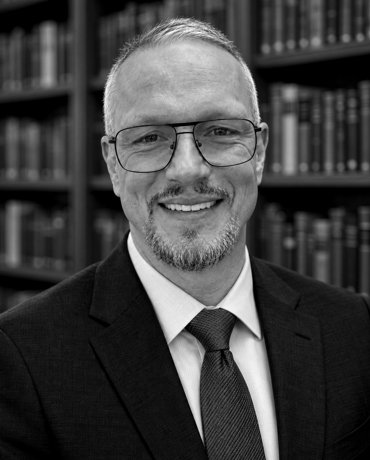 Stephen Deason in front of a bookcase