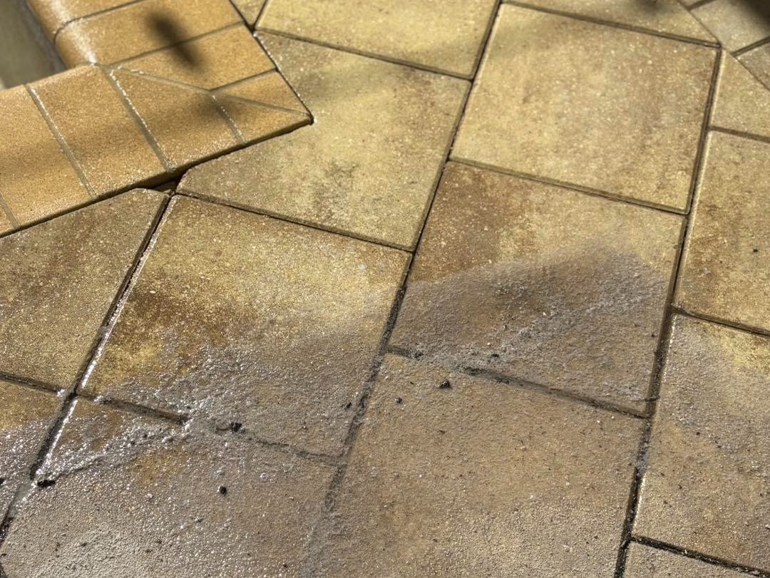 Close view of brown patterned paving with dark joints