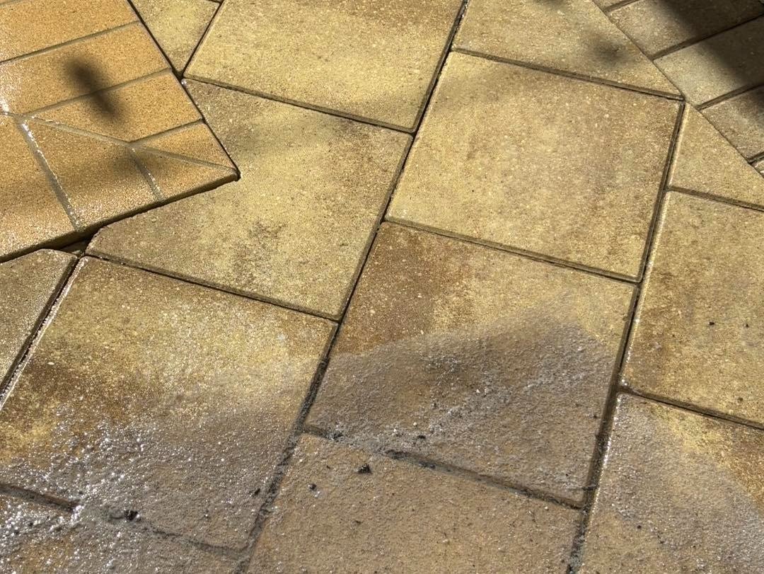Brown rectangular paving panels with darker patches and textured surface