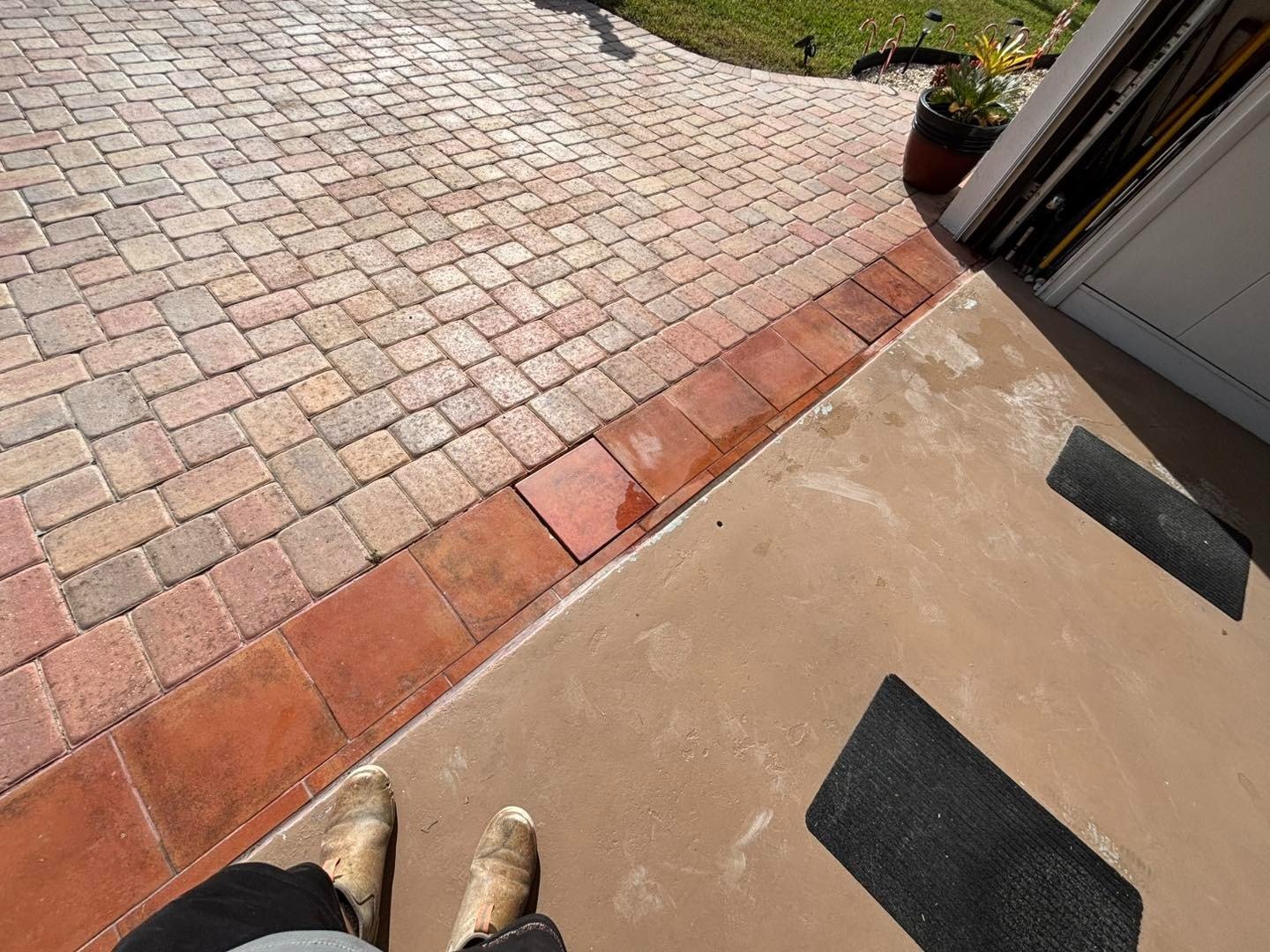View from garage of red threshold pavers and multicolored driveway