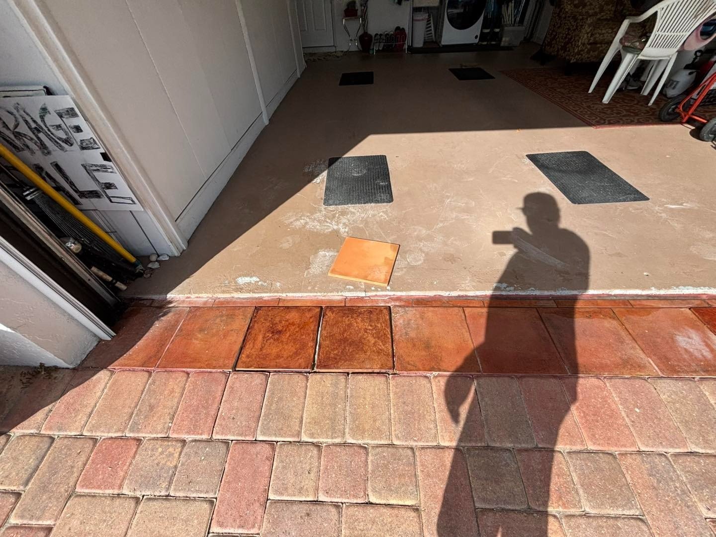 Garage threshold with red paving border and floor sample squares