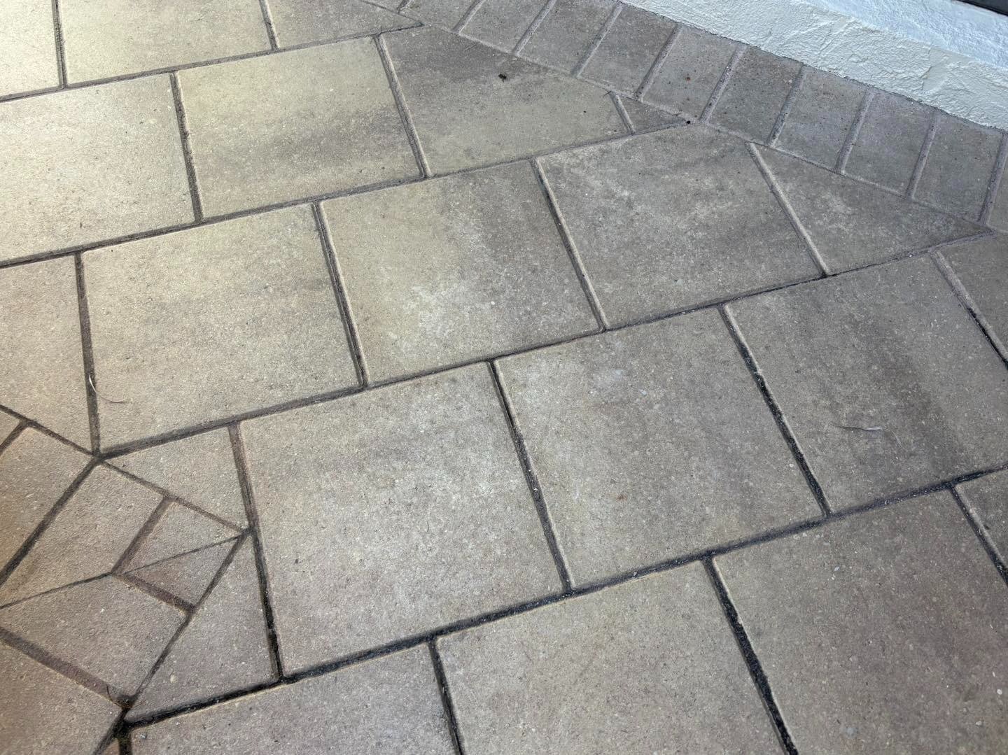 Gray patterned paving with rectangular panels and decorative corner details