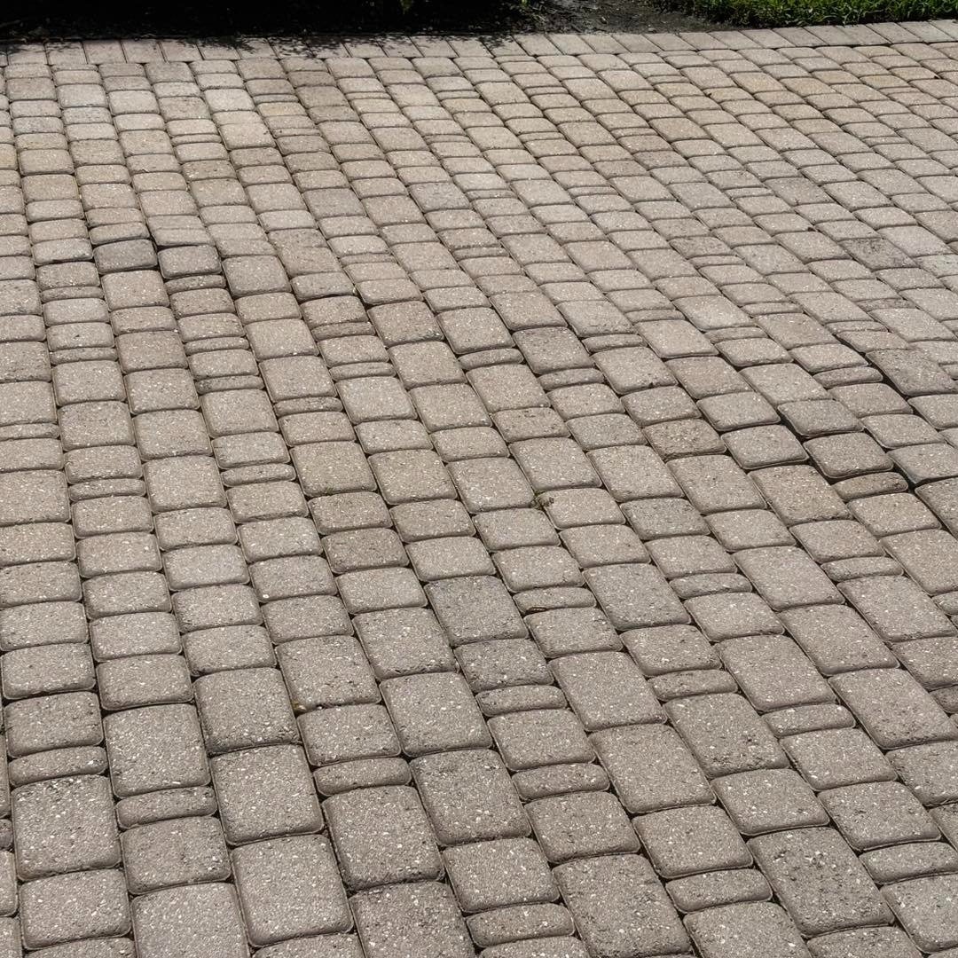 Close view of small rectangular driveway pavers arranged in staggered rows