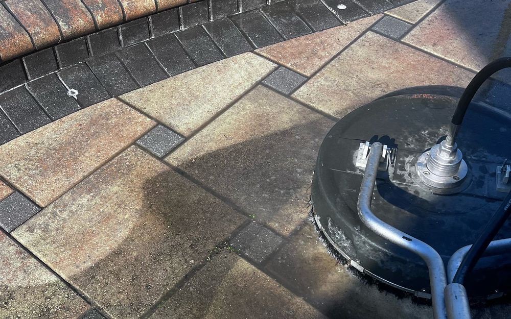 Surface cleaner cleaning a paver pool deck in Cape Coral, FL