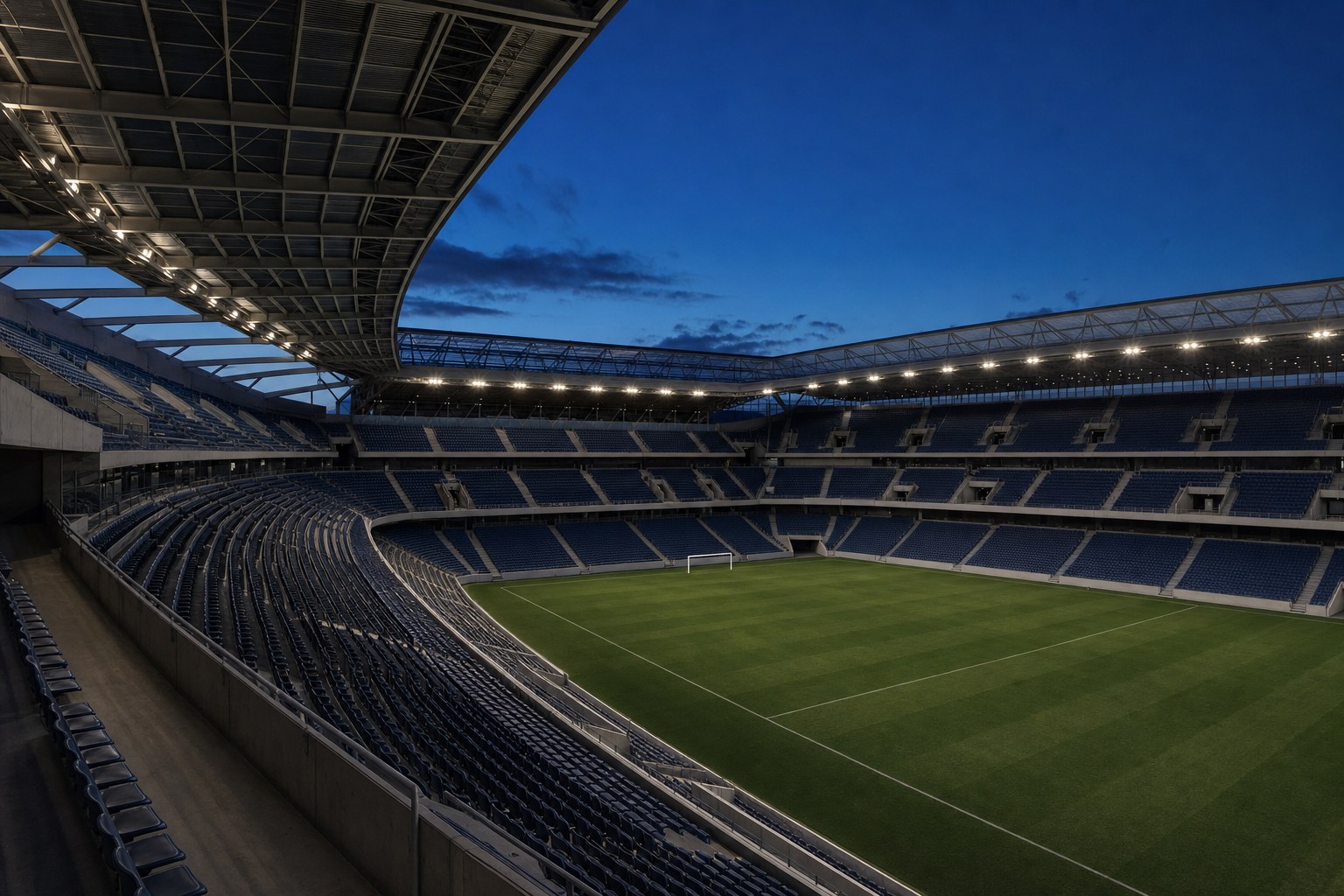 Modern football stadium under evening light
